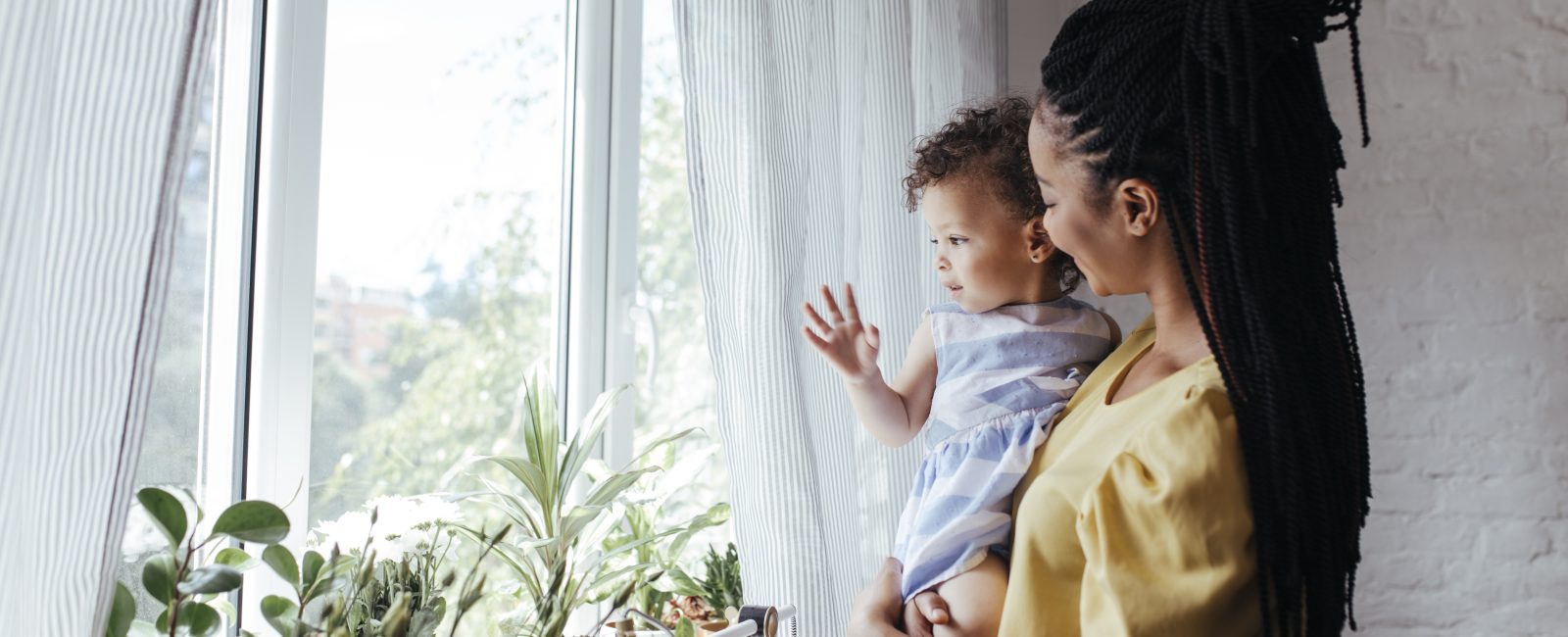 Women and child look out refuge window