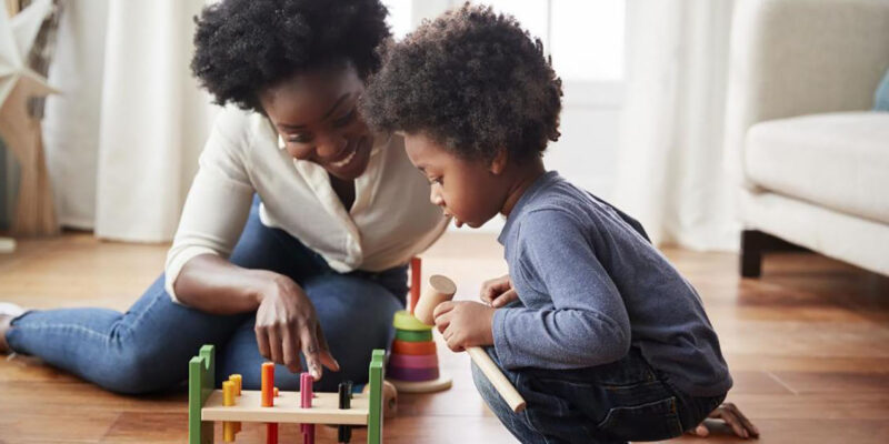 Mother and child playing board game