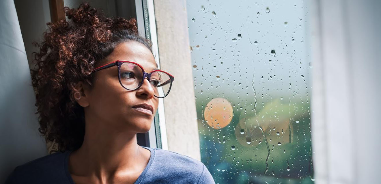 Woman staring pensively out of window