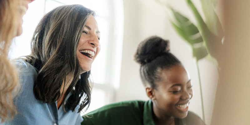 Women round table laughing